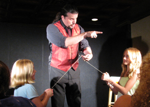 Magician John Shore working with audience members during a performance of The Kentucky MAgic Dinner Theater